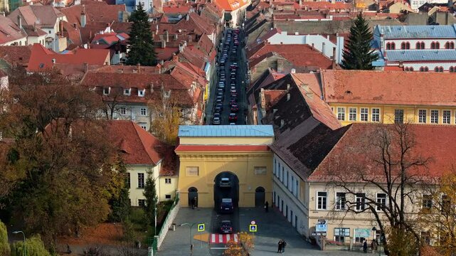 Aerial drone view of cars passing under the Schei Gate in Brasov, Romania