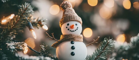 Obraz premium Christmas snowman ornament with fir tree branches and blurred lights background festive winter decoration concept