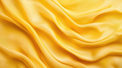 Fototapeta premium Yellow silk fabric texture background with elegant draping and soft folds creating a luxurious and vibrant visual appeal for design use.