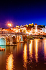 Roman bridge over the Nabao river and Templar castle, Tomar, Santarem district, Medio Tejo, central...