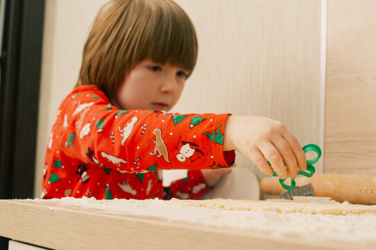 Caucasian boy crafing decorations or opening presents  at home candid shot candind shot winter holiday activities