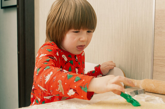Caucasian boy crafing decorations or opening presents  at home candid shot candind shot winter holiday activities