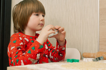 Caucasian boy crafing decorations or opening presents  at home candid shot candind shot winter holiday activities