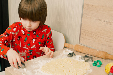 Caucasian boy crafing decorations or opening presents  at home candid shot candind shot winter holiday activities