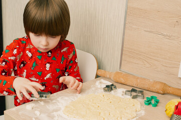 Caucasian boy crafing decorations or opening presents  at home candid shot candind shot winter holiday activities
