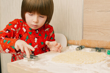 Caucasian boy crafing decorations or opening presents  at home candid shot candind shot winter holiday activities