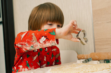 Caucasian boy crafing decorations or opening presents  at home candid shot candind shot winter holiday activities
