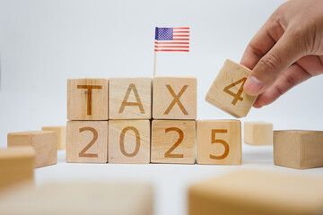 Planning Taxes for 2025 With Wooden Blocks and American Flag