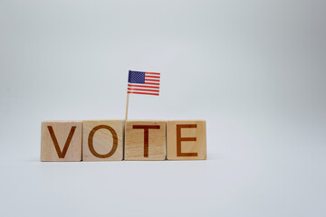 Wooden Blocks Spelling 'Vote' with Small American Flag Adornment