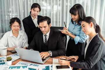 Diverse group of business analyst team analyzing financial data report paper on office table. Chart...