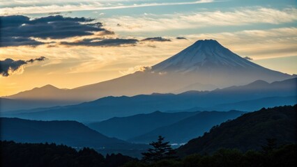 Fototapeta premium Mount fuji, japan's highest mountain, rising majestically with its snow capped peak glowing in the warm golden light of sunset, offers a breathtaking view over surrounding landscapes