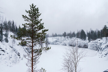 Winter in the park. Karelia Ruskeala Nature Reserve in winter. It is snowing in the forest.