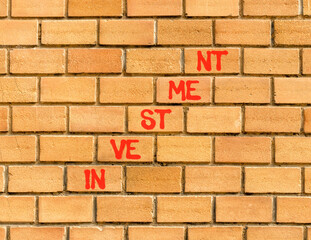 Investment symbol. Concept word Investment on beautiful brown bricks. Beautiful brown brick wall...