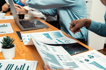 Diverse group of business analyst team analyzing financial data report paper on office table. Chart...