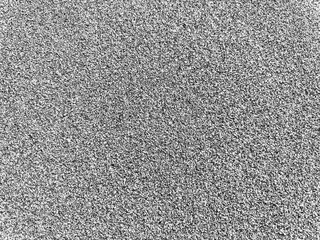 Fototapeta premium Detailed close-up photograph of gray sand grains, captured under natural lighting. The image emphasizes the subtle textures and neutral tones of the sand, making it ideal for themes related to nature.