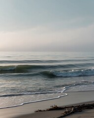 Obraz premium Tranquil Ocean Waves with Soft Light Reflections for Relaxation and Travel Imagery