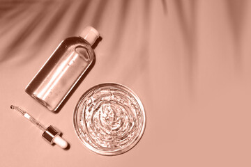 Demonstrating color of the year 2025. Mocha mousse color swatch. Cosmetic serum glass bottle skincare facial treatment, cream, gel, oil dropper pipette