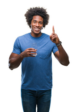 Afro american man drinking glass of water over isolated background surprised with an idea or question pointing finger with happy face, number one