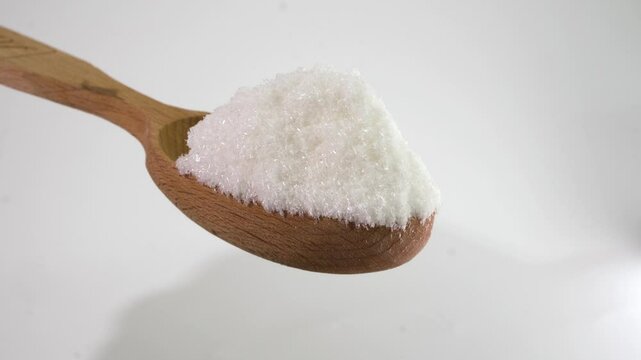 Close up of mono Monosodium glutamate (MSG)in spoon on white