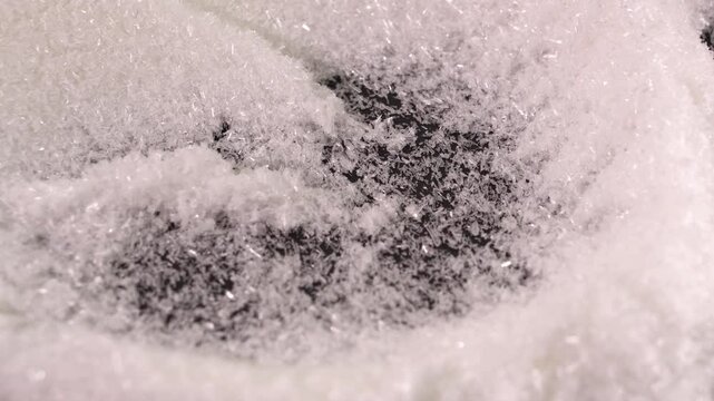 Close up of mono Monosodium glutamate (MSG)in spoon on white