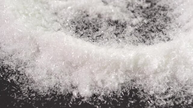 Close up of mono Monosodium glutamate (MSG)in spoon on white