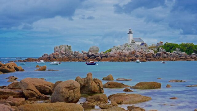 Small motor boats and yachts anchored in the bay, Phare de Pontusval, Brittany, France. Timelapse