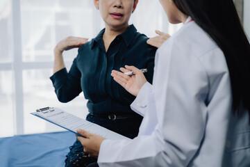 Doctor and Patient: A doctor in a white coat listens attentively to a patient's concerns,...