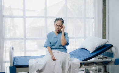 Elderly Woman in Hospital Bed Experiencing Pain 