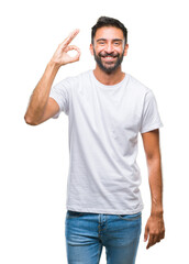Adult hispanic man over isolated background smiling positive doing ok sign with hand and fingers....