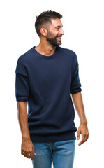 Adult hispanic man over isolated background looking away to side with smile on face, natural expression. Laughing confident.