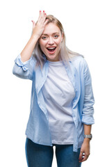 Young blonde woman over isolated background surprised with hand on head for mistake, remember...