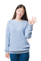 Young Chinese woman over isolated background showing and pointing up with fingers number five while...