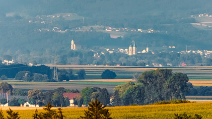 Fototapeta premium Far view of the churches of Hengersberg and Niederalteich seen from near Ettling, Wallersdorf, Dingolfing-Landau, Bavaria, Germany
