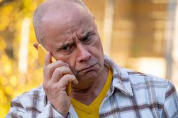 Middle-aged Stressed man shouting angrily on smartphone, stress and uncontrolled emotions in tense...