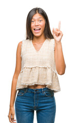 Obraz premium Young asian woman over isolated background pointing finger up with successful idea. Exited and happy. Number one.