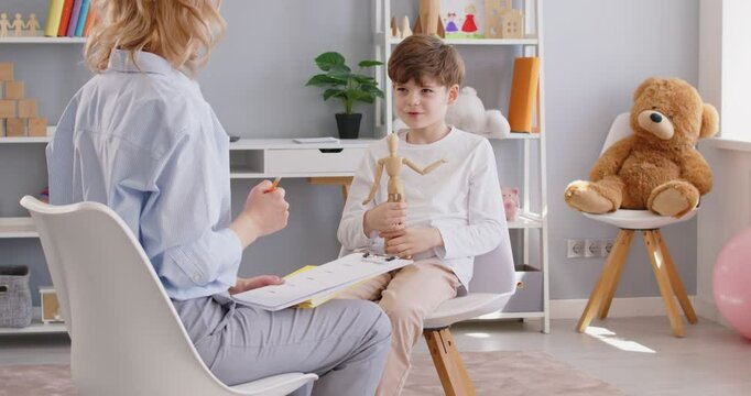 Child psychologist talking to small preschooler boy kid, giving support, comfort, support, development testing. Psychology therapy session for empathy to help cope with problem, psychological study