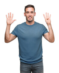 Naklejka premium Handsome young casual man showing and pointing up with fingers number nine while smiling confident and happy.