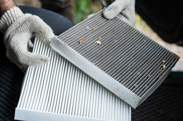 The master changes the cabin air filter of the car.