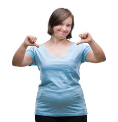Young adult woman with down syndrome over isolated background looking confident with smile on face,...