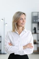 Fototapeta premium Portrait of businesswoman with crossed arms in office