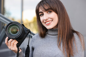 Professional photographer with digital camera near building outdoors