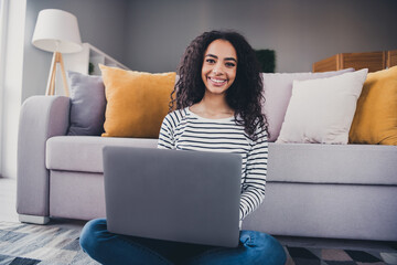 Photo of nice young girl use laptop floor wear striped pullover living room apartment indoors