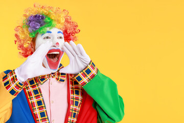 Portrait of clown screaming on yellow background, space for text