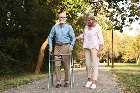 Senior couple with walking frame in park