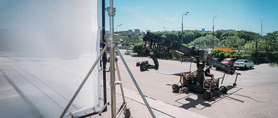Professional film and video camera on a telescopic cinema crane on the set.