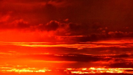 Fototapeta premium Abstract dark red and yellow sky background with burning sky effect, and rays of sunlight during sunset. Topics: hot colors, cloudy background, weather, meteorology, climate, air space, atmosphere