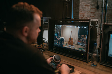 Director at work on the set. The director works with a group or with a playback while filming a...