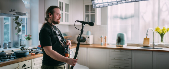 Sound engineer with a microphone on the set. A professional sound engineer at work on the filming...