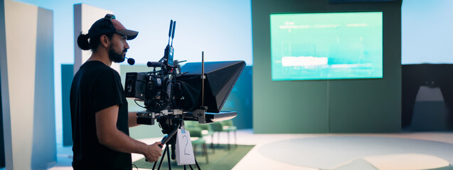 Director of photography with a camera in his hands on the set. Professional videographer at work on...