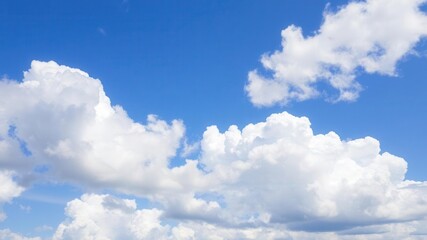 Obraz premium Beautiful white fluffy clouds floating in a clear blue sky on a sunny summer day, nature, weather, scenic